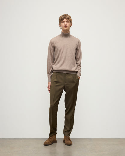 MODEL WEARING JOHNSTONS OF ELGIN MENS SUPERFINE FIN ROLL COLLAR GREY 100% SUPERFINE CASHMERE WITH OLIVE TROUSERS KAI05333HB0273