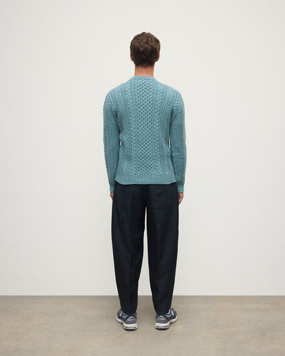 Model wearing Johnstons of Elgin AW25 Men's Knitwear Seascape Aran Cable Green Cashmere Jumper Back KAI05336HC0038