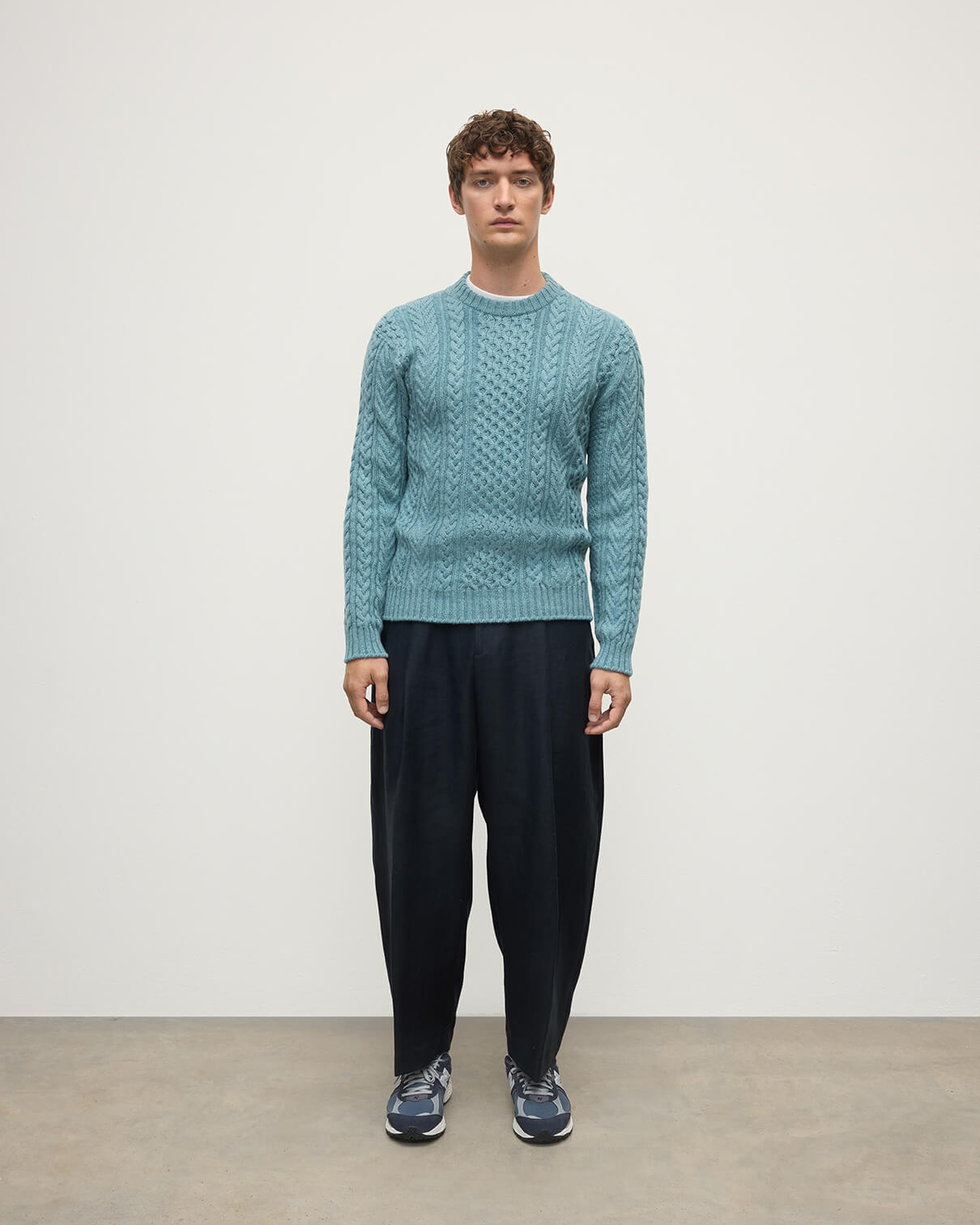 Model wearing Johnstons of Elgin AW25 Men's Knitwear Seascape Aran Cable Green Cashmere Jumper Front KAI05336HC0038
