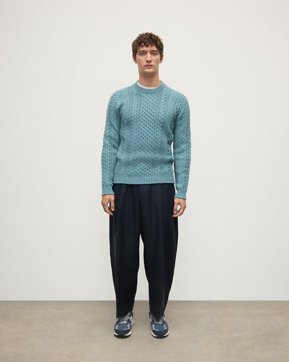 Model wearing Johnstons of Elgin AW25 Men's Knitwear Seascape Aran Cable Green Cashmere Jumper Front KAI05336HC0038