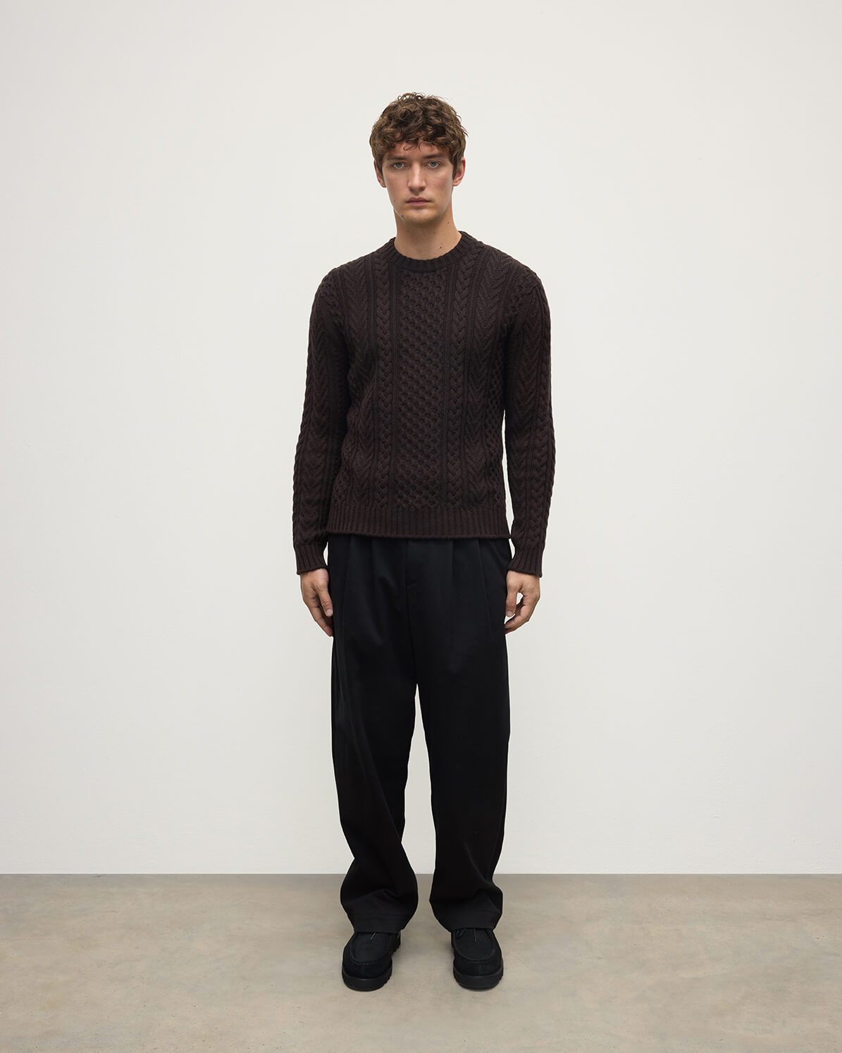 Model wearing Johnstons of Elgin AW25 Men's Knitwear Molasses Aran Cable Brown Cashmere Jumper Front KAI05336SB7290