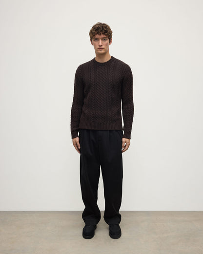 Model wearing Johnstons of Elgin AW25 Men's Knitwear Molasses Aran Cable Brown Cashmere Jumper Front KAI05336SB7290