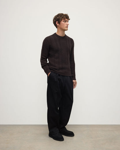 Model wearing Johnstons of Elgin AW25 Men's Knitwear Molasses Aran Cable Brown Cashmere Jumper Side KAI05336SB7290