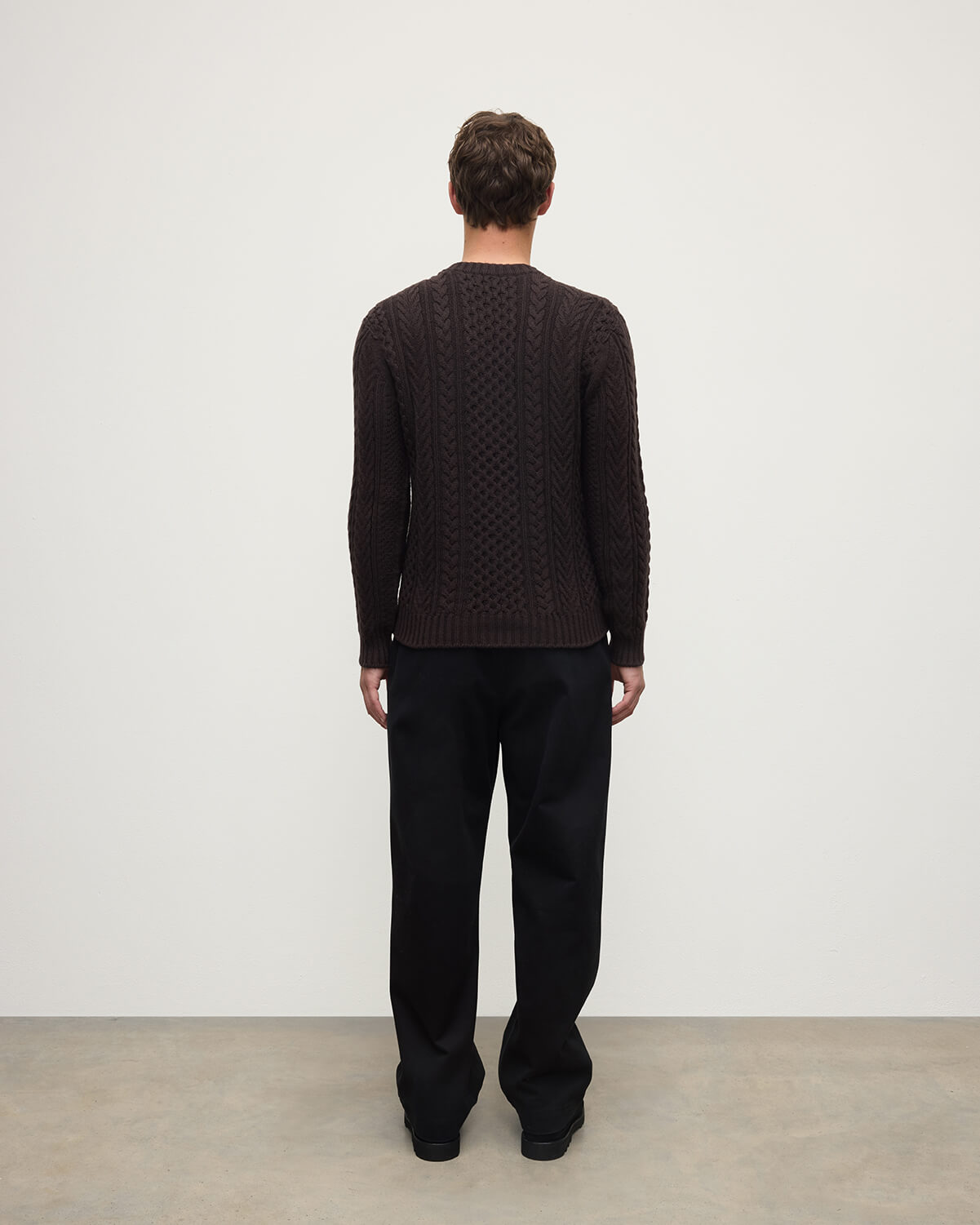 Model wearing Johnstons of Elgin AW25 Men's Knitwear Molasses Aran Cable Brown Cashmere Jumper Back KAI05336SB7290