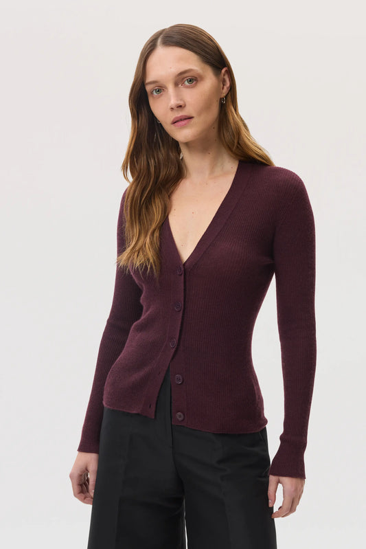 Model wears Johnstons of Elgin SS25 Women's Knitwear Rosewood Superfine Cashmere Ribbed Cardigan with black shorts KAI05372SB7255