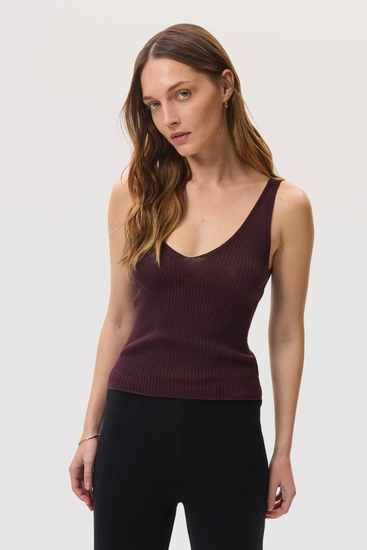 Model wears Johnstons of Elgin SS25 Women's Knitwear Rosewood Ribbed Superfine Cashmere Vest with black trousers on a white backdrop KAI05446SB7255