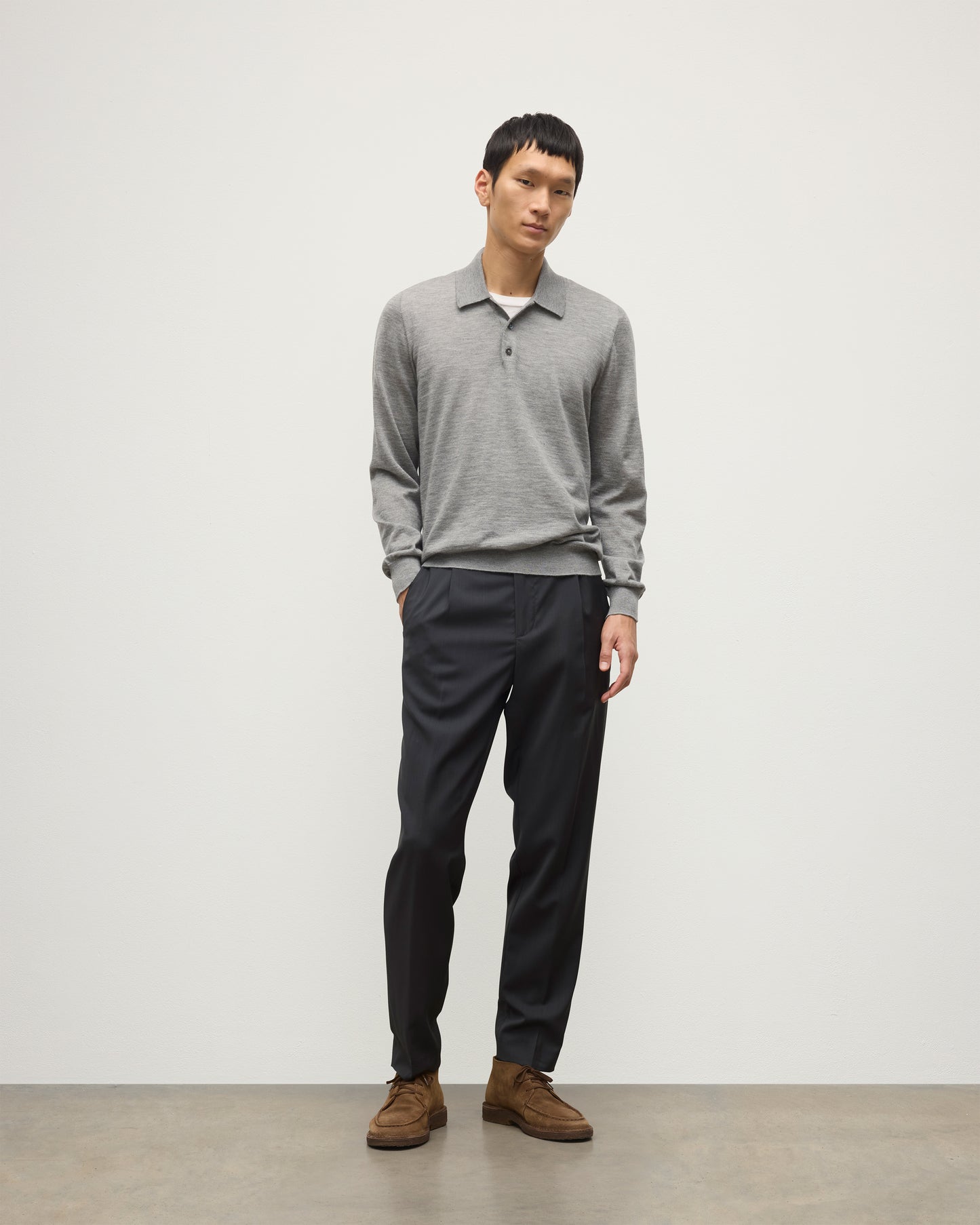 MODEL WEARING JOHNSTONS OF ELGIN MENS FIN SUPERFINE LONG SLEEVE POLOSHIRT GREY 100% SUPERFINE CASHMERE WITH BLACK TROUSERS KAI05481HA4253