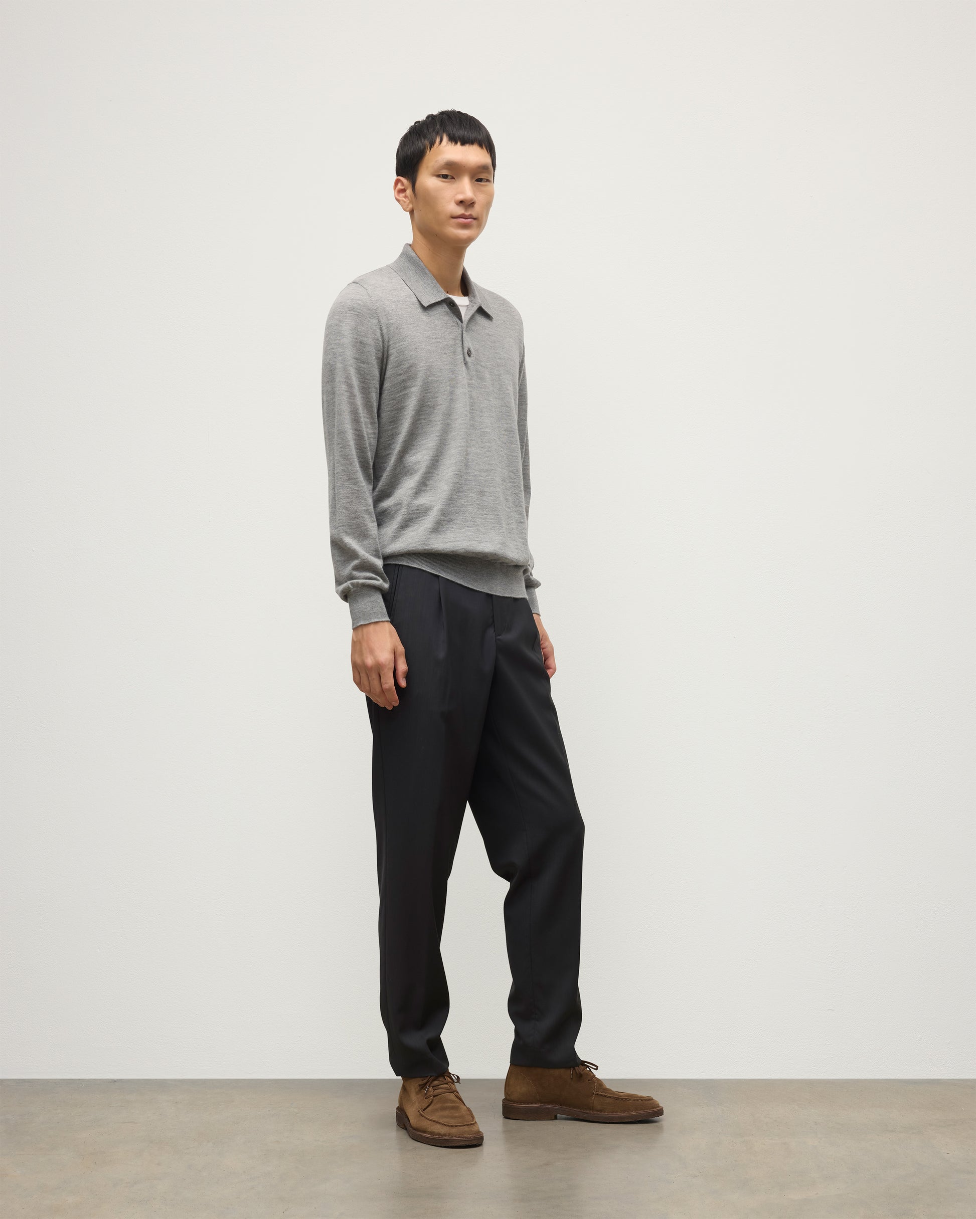 MODEL WEARING JOHNSTONS OF ELGIN MENS FIN SUPERFINE LONG SLEEVE POLOSHIRT GREY 100% SUPERFINE CASHMERE WITH BLACK TROUSERS KAI05481HA4253