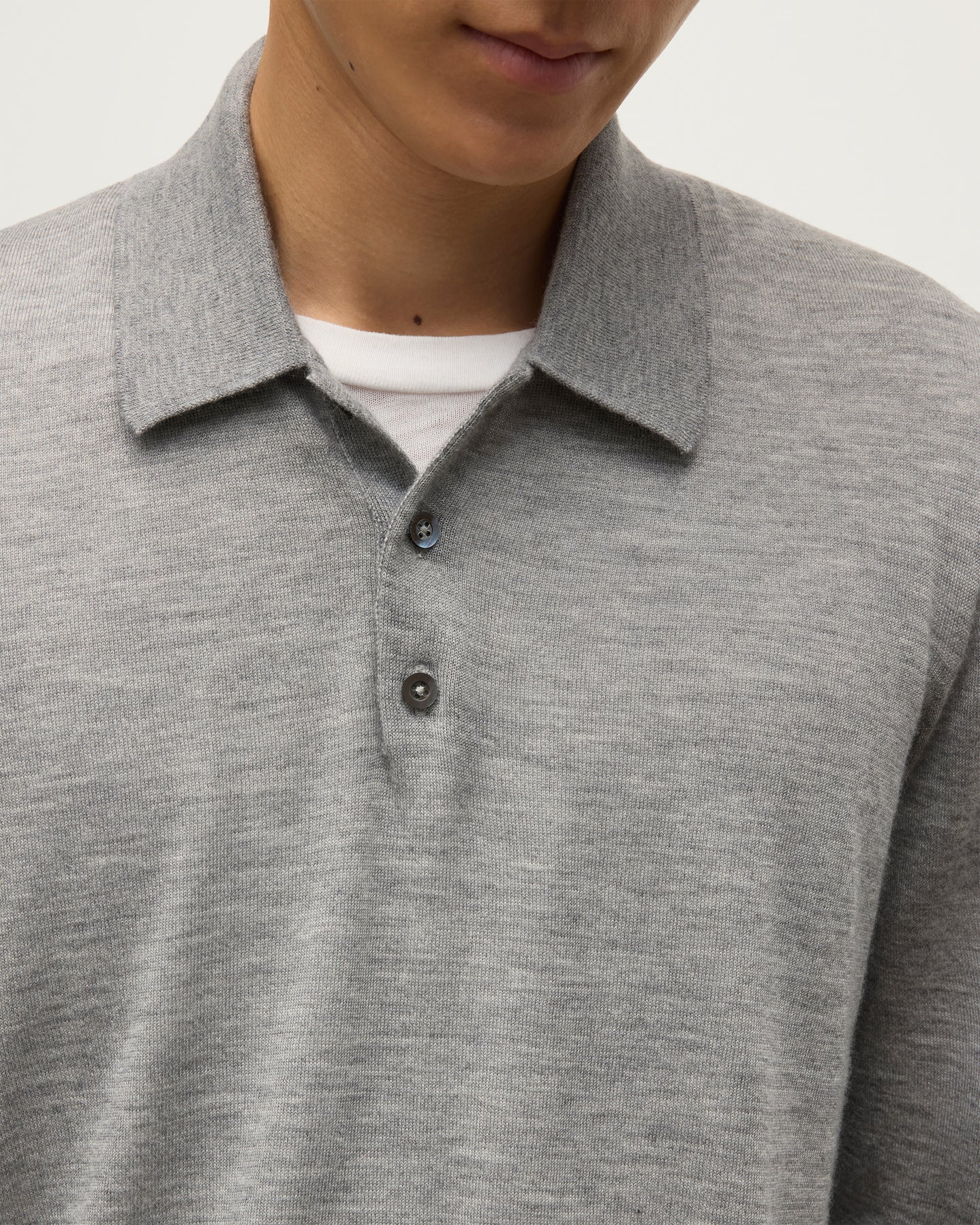 MODEL WEARING JOHNSTONS OF ELGIN MENS FIN SUPERFINE LONG SLEEVE POLOSHIRT GREY 100% SUPERFINE CASHMERE OVER A WHITE T-SHIRT  KAI05481HA4253