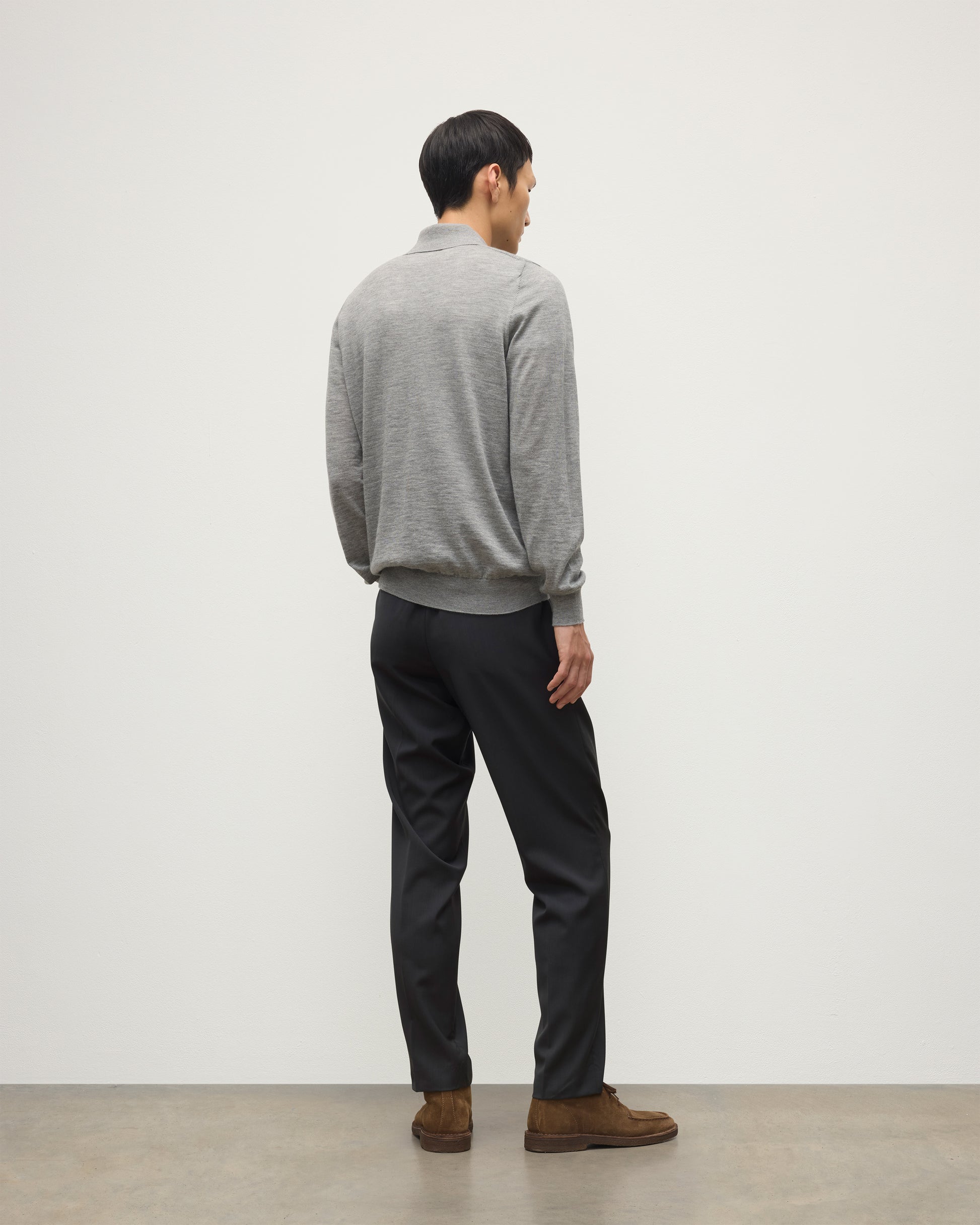 MODEL WEARING JOHNSTONS OF ELGIN MENS FIN SUPERFINE LONG SLEEVE POLOSHIRT GREY 100% SUPERFINE CASHMERE WITH BLACK TROUSERS KAI05481HA4253