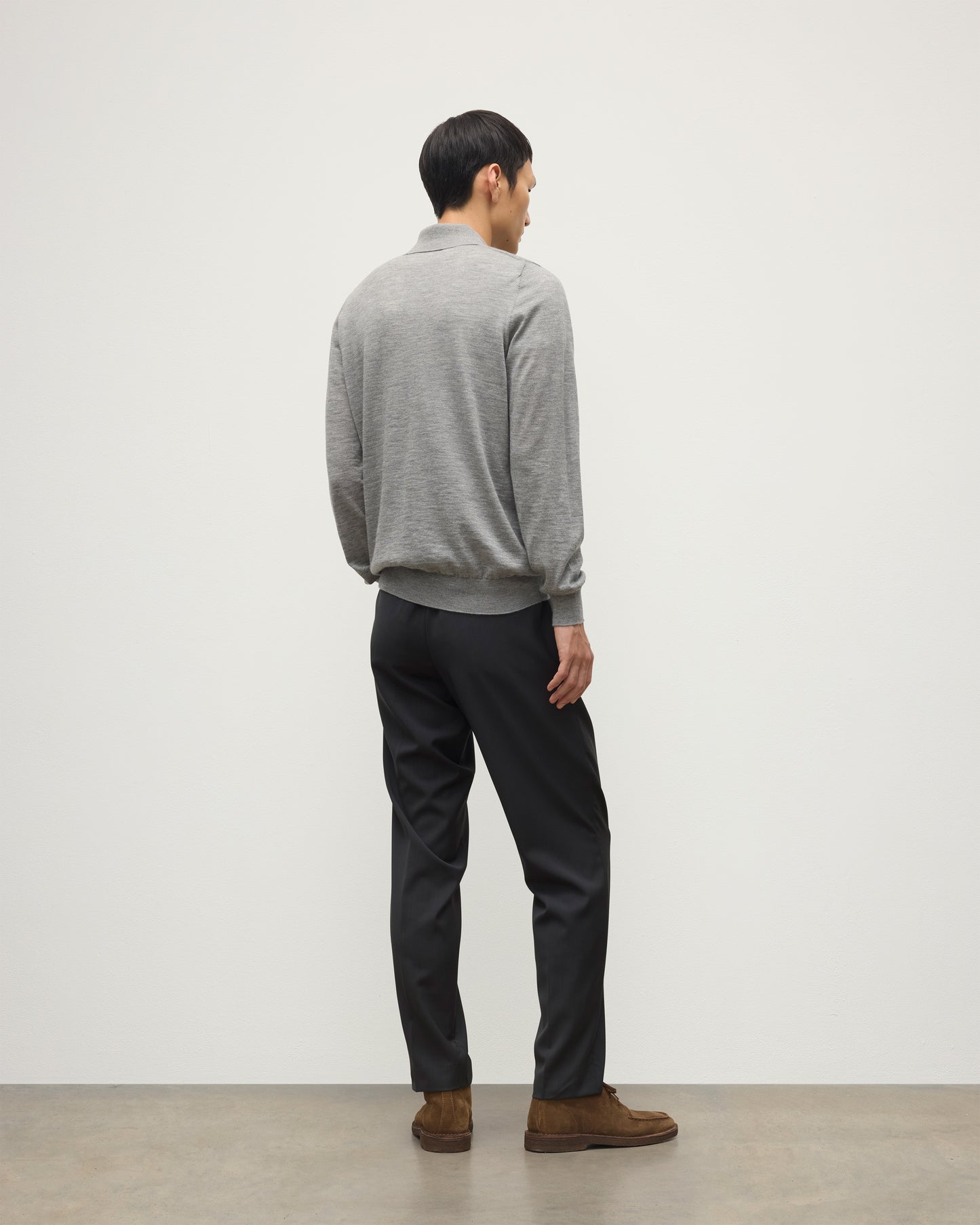 MODEL WEARING JOHNSTONS OF ELGIN MENS FIN SUPERFINE LONG SLEEVE POLOSHIRT GREY 100% SUPERFINE CASHMERE WITH BLACK TROUSERS KAI05481HA4253