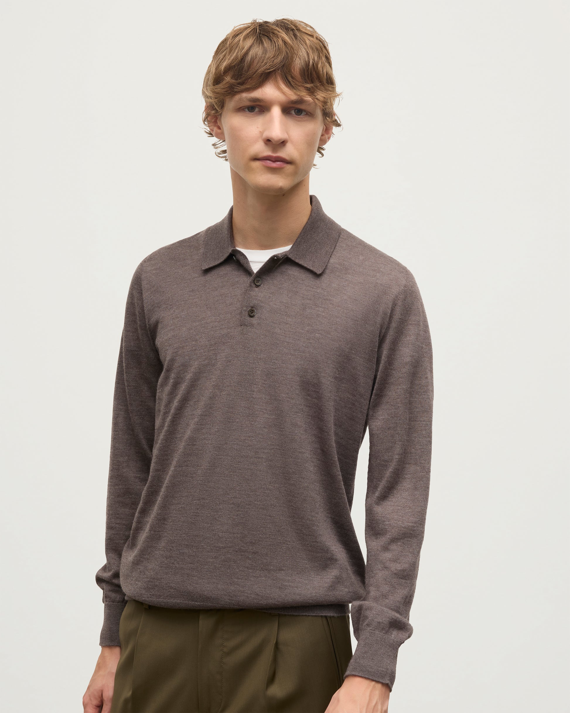 MODEL WEARS JOHNSTONS OF ELGIN MENS FIN SUPERFINE LONG SLEEVE POLOSHIRT LIGHT BROWN OVER A KAI05481HB7092