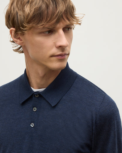 MODEL WEARS JOHNSTONS OF ELGIN MENS FIN SUPERFINE LONG SLEEVE POLOSHIRT NAVY 100% SUPERFINE CASHMERE OVER A WHITE T-SHIRT KAI05481HD7350