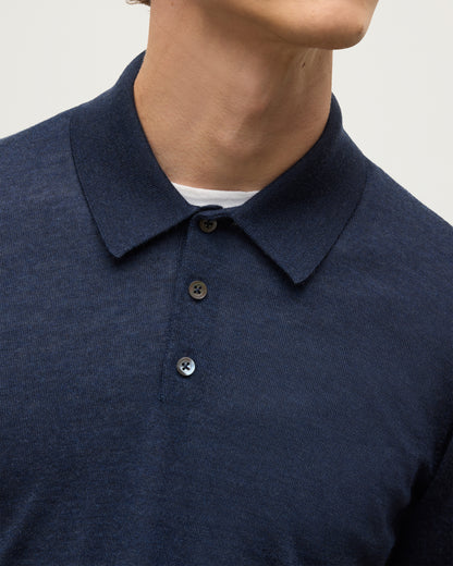 MODEL WEARS JOHNSTONS OF ELGIN MENS FIN SUPERFINE LONG SLEEVE POLOSHIRT NAVY 100% SUPERFINE CASHMERE OVER A WHITE T-SHIRT KAI05481HD7350