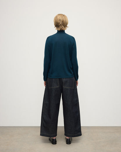 Model wears Johnstons of Elgin AW25 Women's Knitwear Bottle Green Superfine Cashmere Green Roll Neck Jumper Back View  KAI05607SC7344