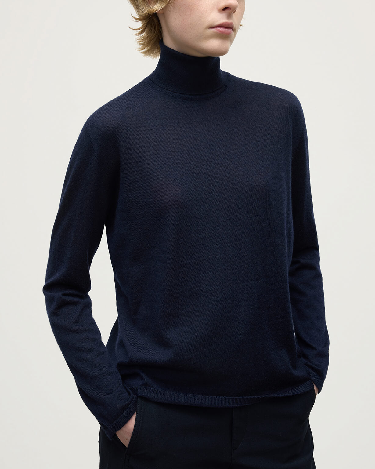 Model wears Johnstons of Elgin AW25 Women's Knitwear Dark Navy Superfine Cashmere Navy Roll Neck Jumper Close Up KAI05607SD7600