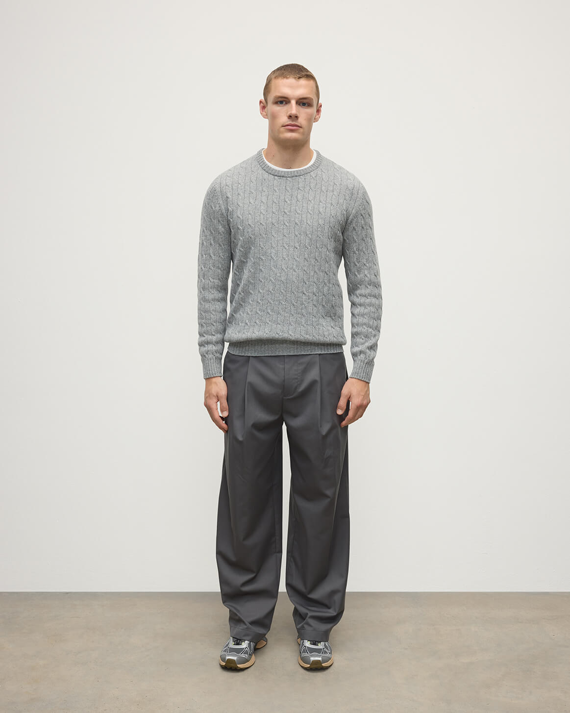 Model wears Johnstons of Elgin AW25 Men's Knitwear Light Grey Cable Knit Grey Cashmere Jumper Front KAI05693HA0308