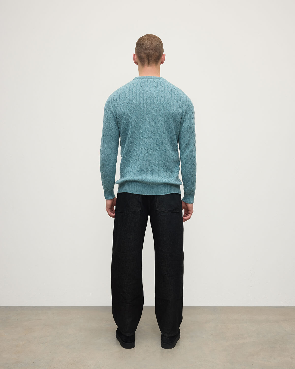 Model wearing Johnstons of Elgin AW25 Men's Knitwear Seascape Cable Knit Green Cashmere Jumper Back KAI05693HC0038