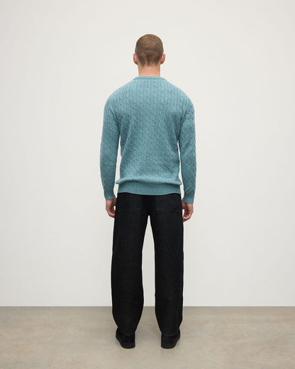 Model wearing Johnstons of Elgin AW25 Men's Knitwear Seascape Cable Knit Green Cashmere Jumper Back KAI05693HC0038