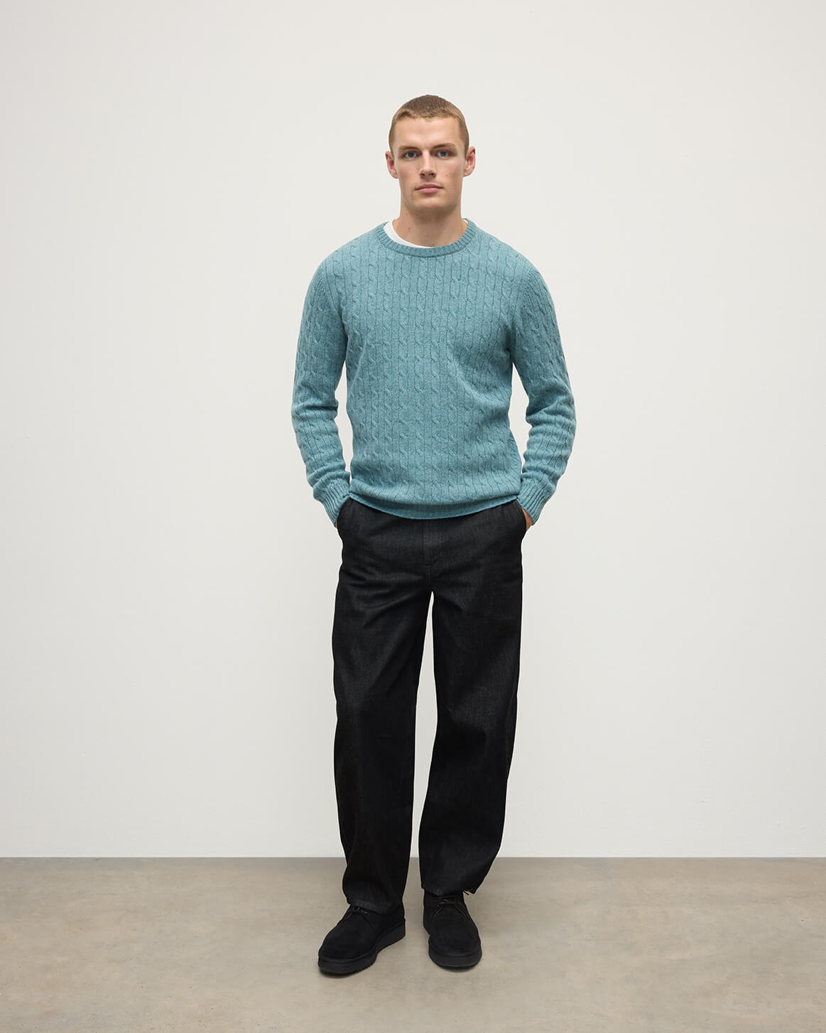 Model wearing Johnstons of Elgin AW25 Men's Knitwear Seascape Cable Knit Green Cashmere Jumper Front KAI05693HC0038