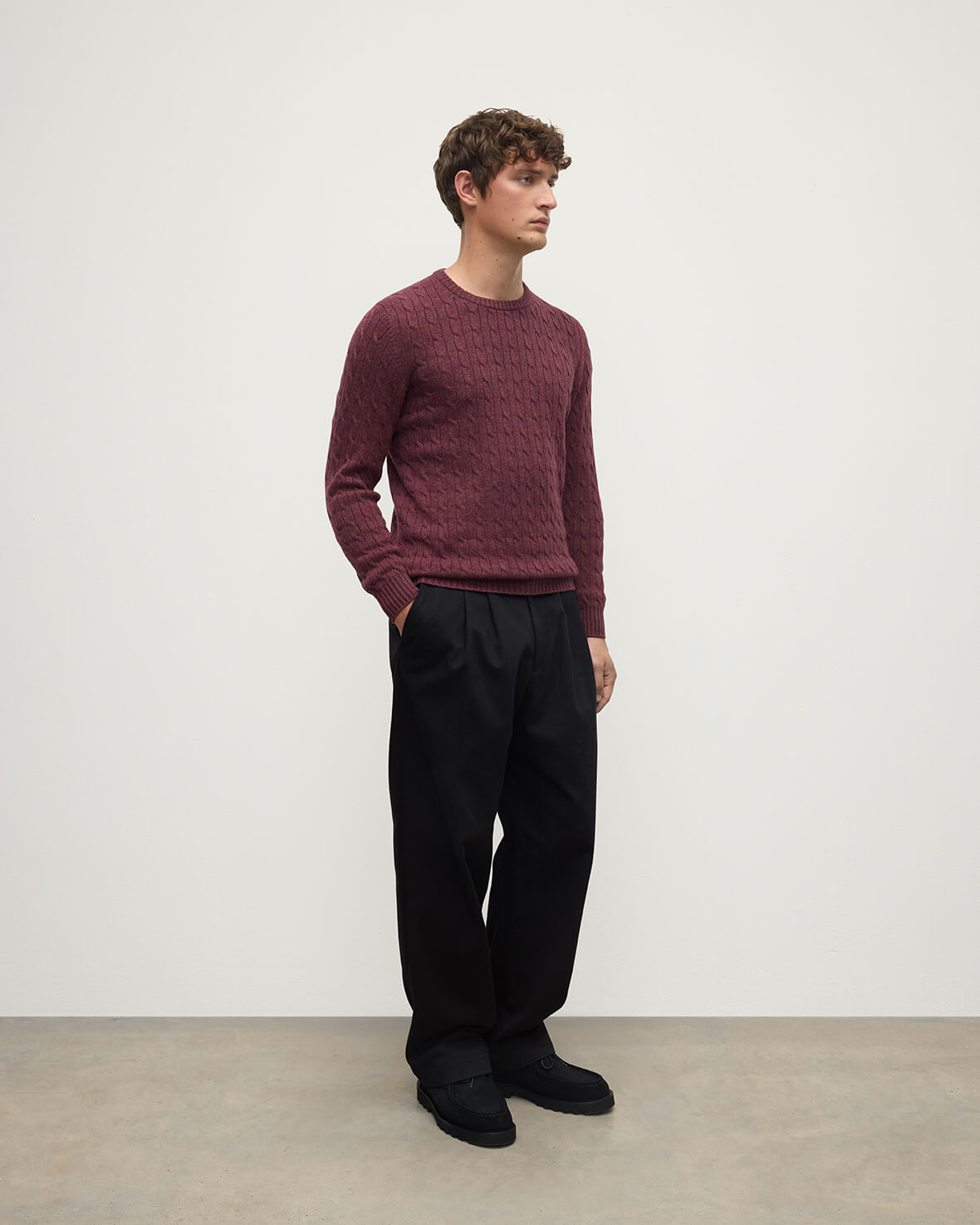 Model wears Johnstons of Elgin AW25 Men's Knitwear Damson Cable Knit Cashmere Jumper Side KAI05693HE7064