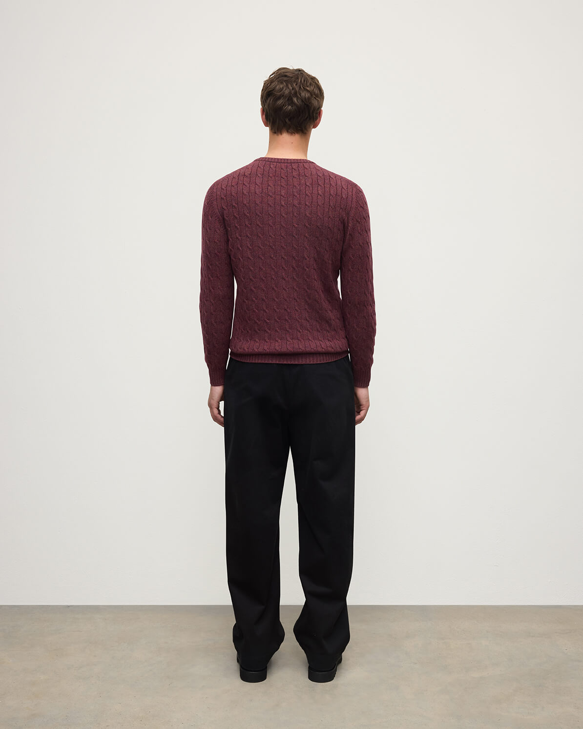 Model wears Johnstons of Elgin AW25 Men's Knitwear Damson Cable Knit Cashmere Jumper back   KAI05693HE7064