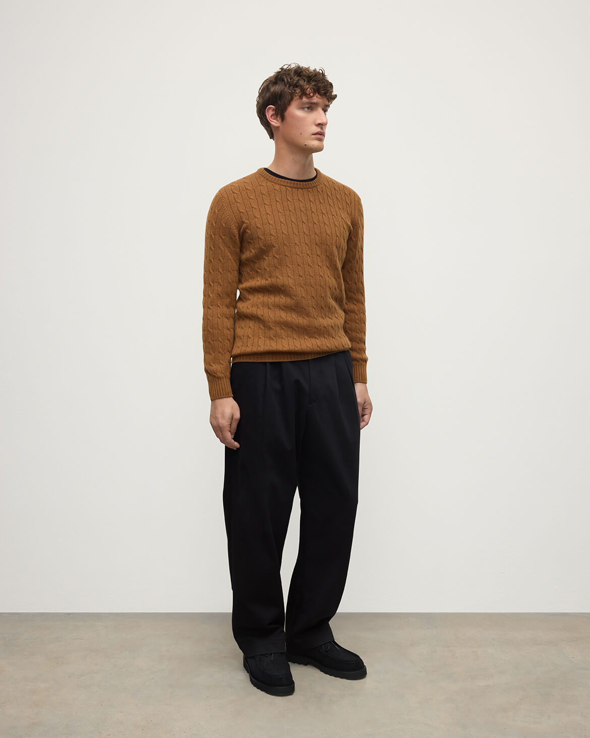 Model wearing Johnstons of Elgin AW25 Men's Knitwear Dark Camel Cable Knit Camel Cashmere Jumper Side KAI05693SB4620