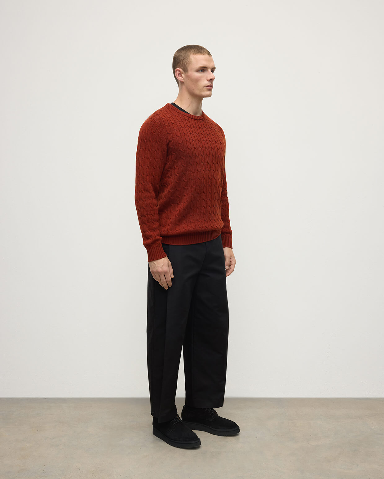 Model wearing Johnstons of Elgin AW25 Men's Knitwear Oxblood Cable Knit Red Cashmere Jumper Side KAI05693SG4463