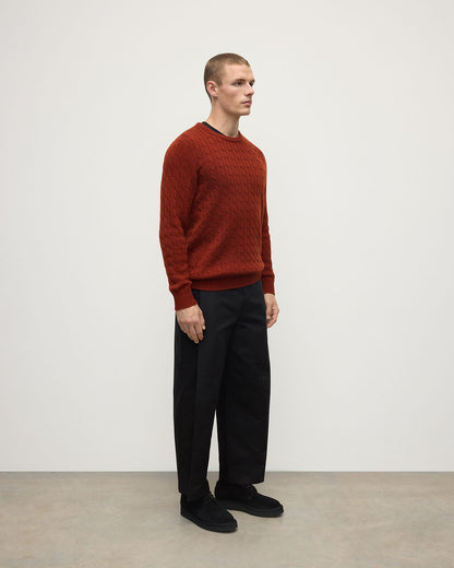 Model wearing Johnstons of Elgin AW25 Men's Knitwear Oxblood Cable Knit Red Cashmere Jumper Side KAI05693SG4463