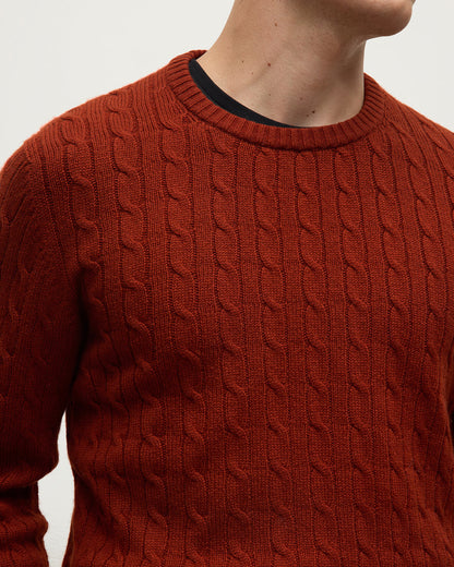 Model wearing Johnstons of Elgin AW25 Men's Knitwear Oxblood Cable Knit Red Cashmere Jumper details KAI05693SG4463