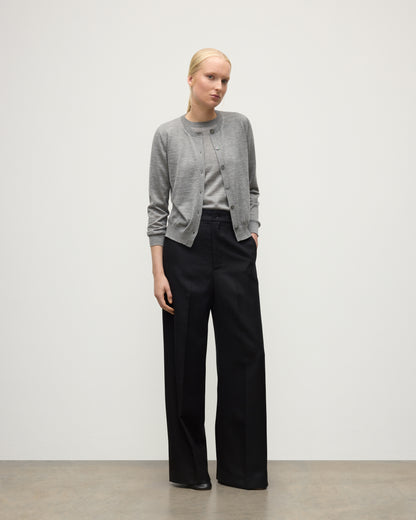 MODEL WEARING JOHNSTONS OF ELGIN WOMENS HONOR CREW CARDIGAN GREY 100% SUPERFINE CASHMERE OVER A MATCHING T-SHIRT WITH BLACK TROUSERS KAI05708HA4253