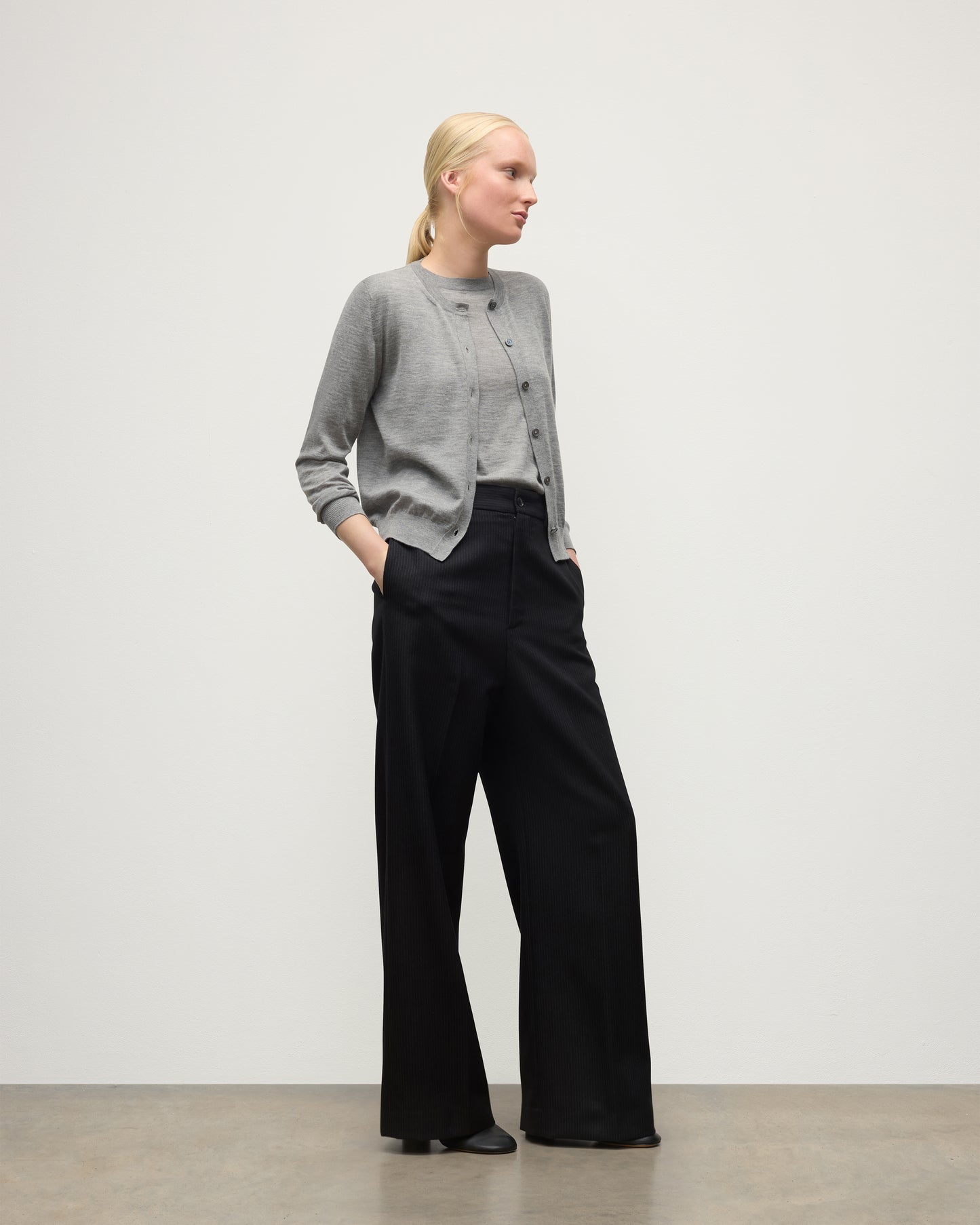 MODEL WEARING JOHNSTONS OF ELGIN WOMENS HONOR CREW CARDIGAN GREY 100% SUPERFINE CASHMERE OVER A MATCHING T-SHIRT WITH BLACK TROUSERS KAI05708HA4253