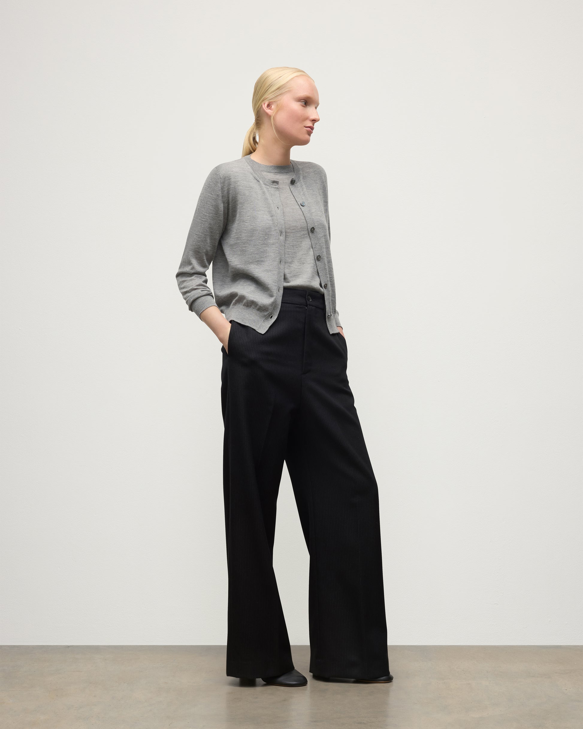 MODEL WEARING JOHNSTONS OF ELGIN WOMENS HONOR CREW CARDIGAN GREY 100% SUPERFINE CASHMERE OVER A MATCHING T-SHIRT WITH BLACK TROUSERS KAI05708HA4253