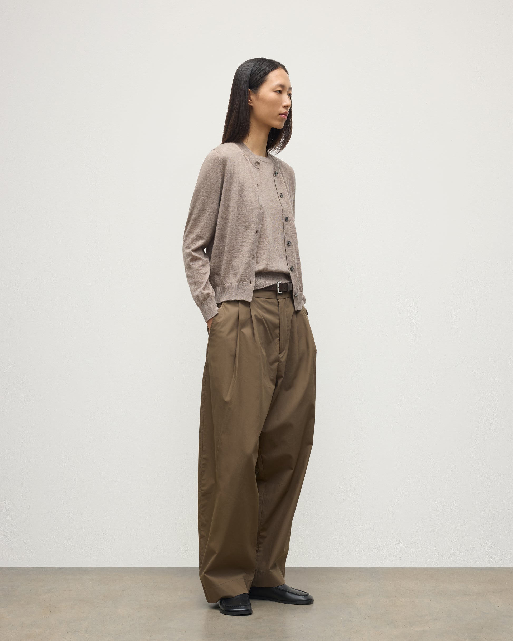 MODEL WEARING JOHNSTONS OF ELGIN WOMENS HONOR CREW CARDIGAN LIGHT BROWN 100% SUPERFINE CASHMERE OVER A MATCHING CASHMERE T-SHIRT WITH BROWN WIDE LEG TROUSERS  KAI05708HB0273