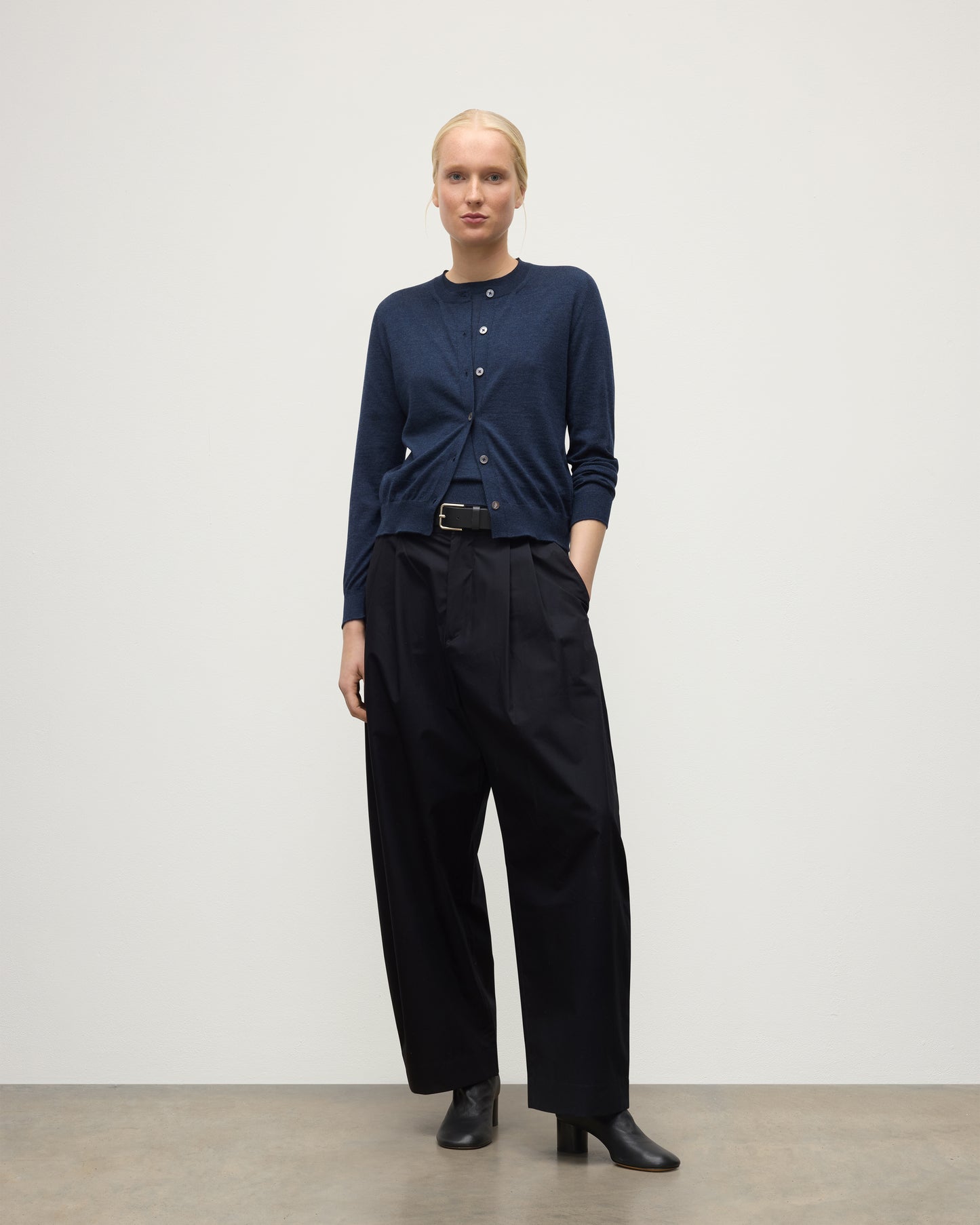 MODEL WEARS JOHHNSTONS OF ELGIN WOMENS HONOR CREW CARDIGAN NAVY 100% SUPERFINE CASHMERE OVER MATCHING CASHMERE T-SHIRT & BLACK TROUSERS KAI05708HD7350