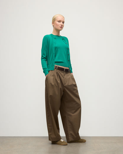 MODEL WEARING JOHNSTONS OF ELGIN WOMENS HONOR CREW CARDIGAN GREEN 100% SUPERFINE CASHMERE WITH BROWN BELTED CHINOS KAI05708SC4714