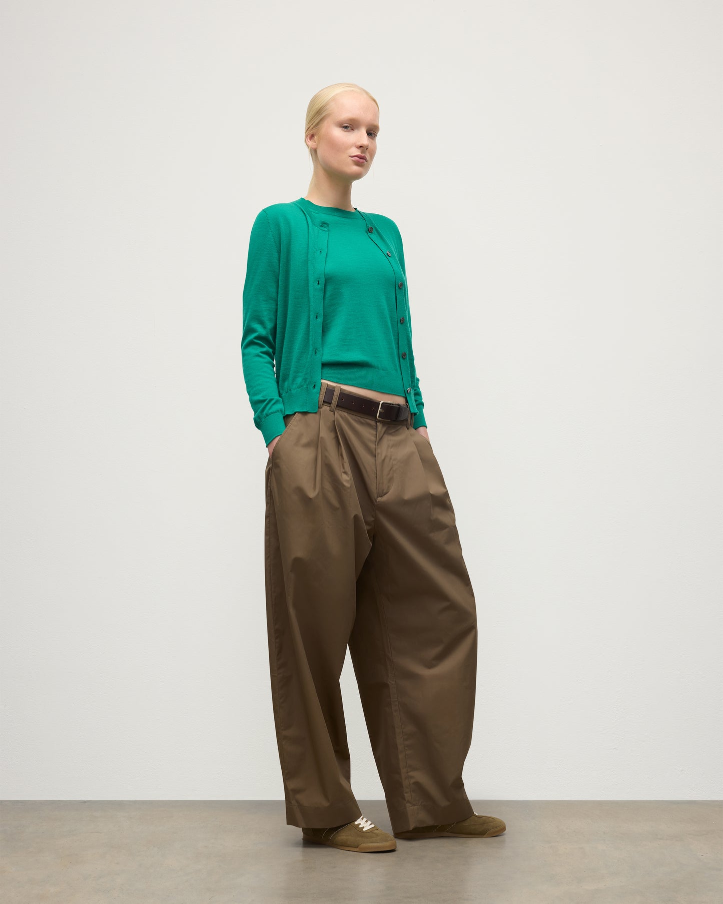 MODEL WEARING JOHNSTONS OF ELGIN WOMENS HONOR CREW CARDIGAN GREEN 100% SUPERFINE CASHMERE WITH BROWN BELTED CHINOS KAI05708SC4714