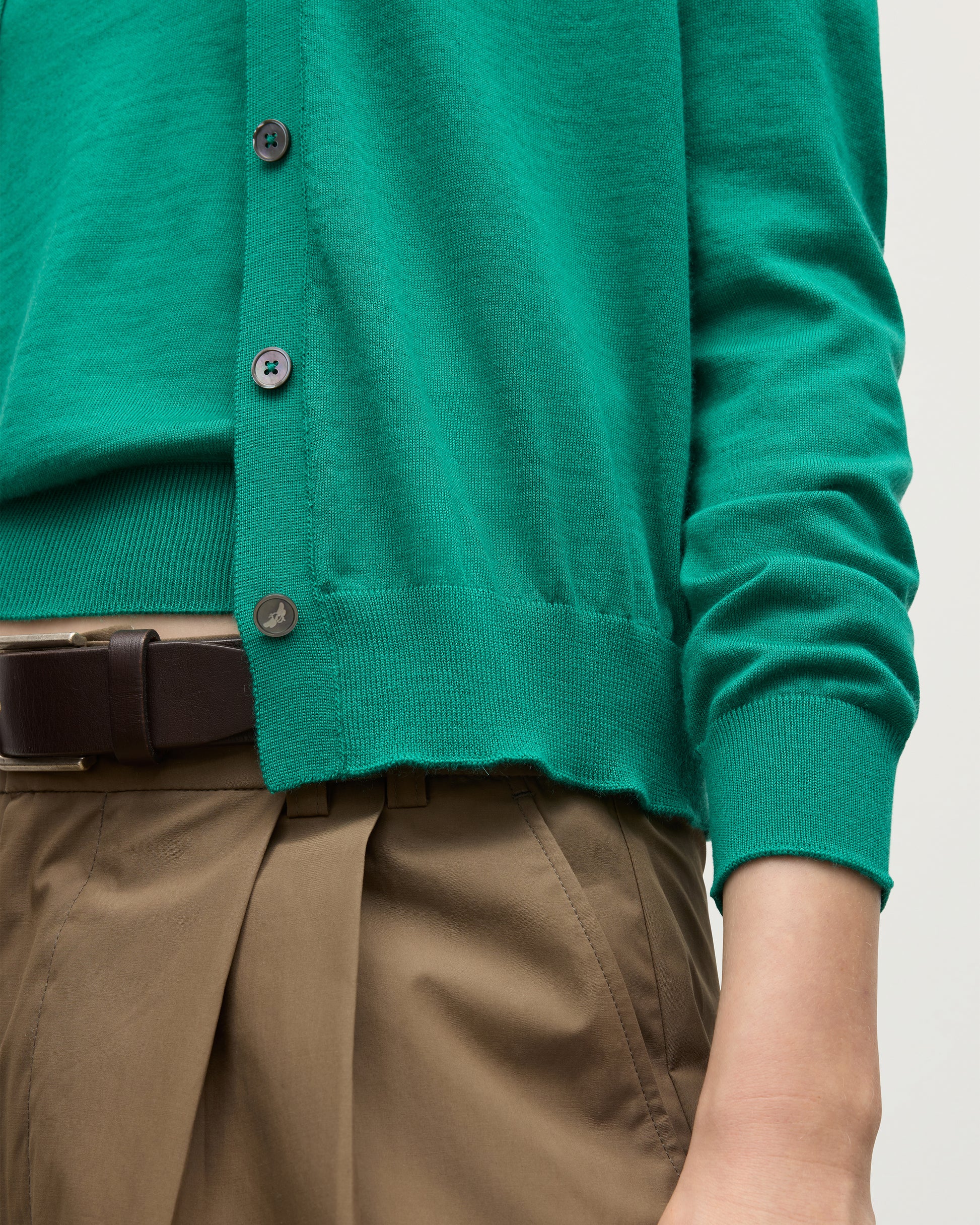 MODEL WEARING JOHNSTONS OF ELGIN WOMENS HONOR CREW CARDIGAN GREEN 100% SUPERFINE CASHMERE WITH BROWN BELTED CHINOS CLOSE UP DETAILS KAI05708SC4714