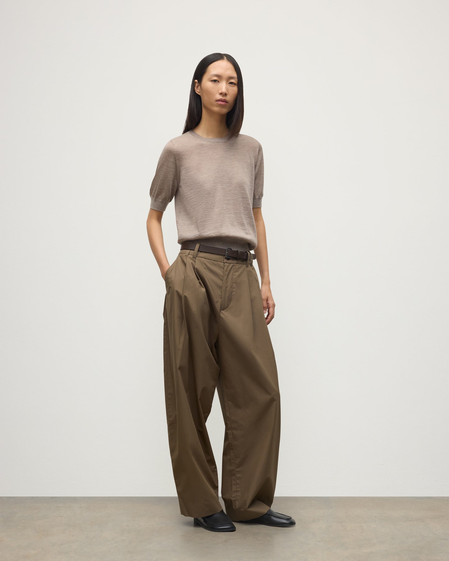 MODEL WEARING JOHNSTONS OF ELGIN WOMENS HONOR SHORT SLEEVE CREW LIGHT BROWN 100% SUPERFINE CASHMERE WITH BROWN WIDE LEG TROUSER KAI05712HB0273