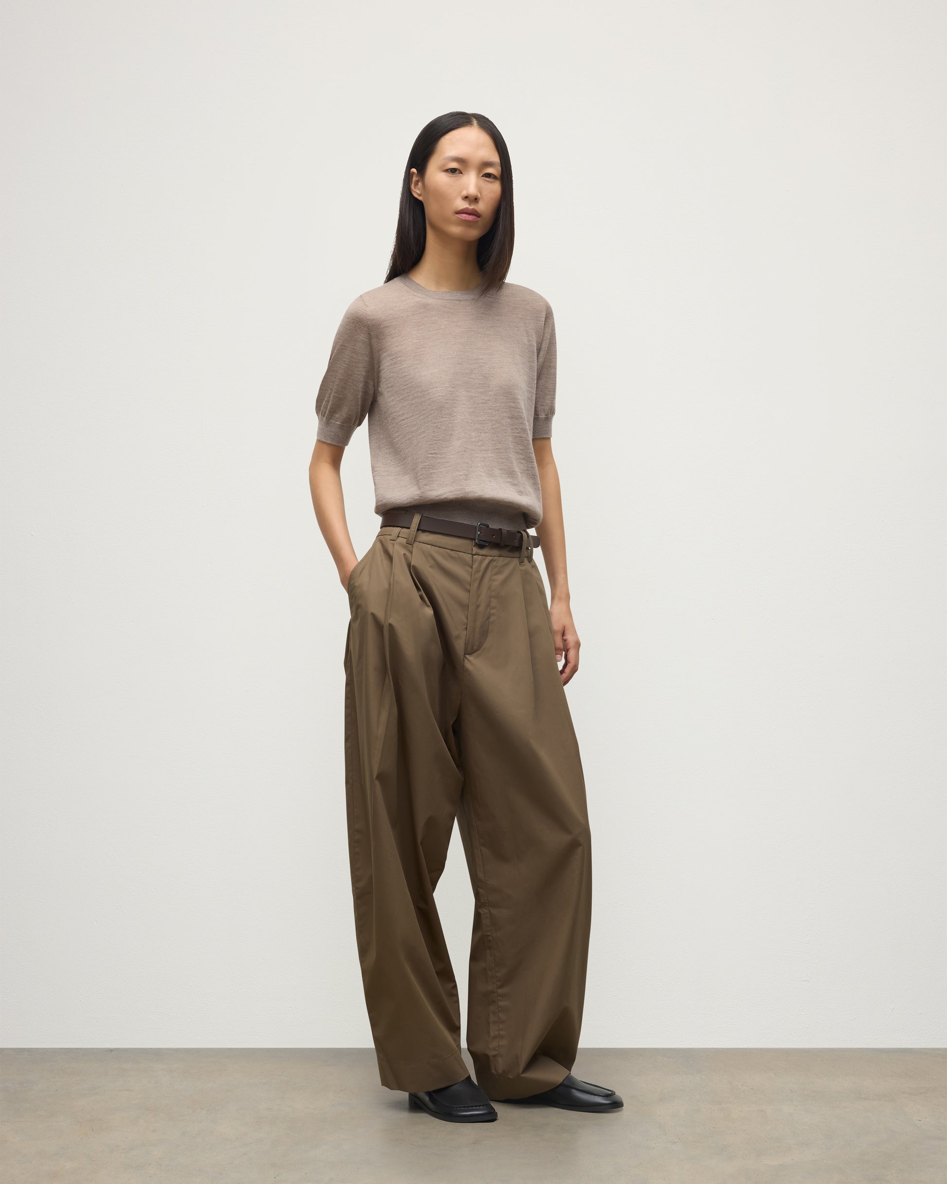 MODEL WEARING JOHNSTONS OF ELGIN WOMENS HONOR SHORT SLEEVE CREW LIGHT BROWN 100% SUPERFINE CASHMERE WITH BROWN WIDE LEG TROUSER KAI05712HB0273