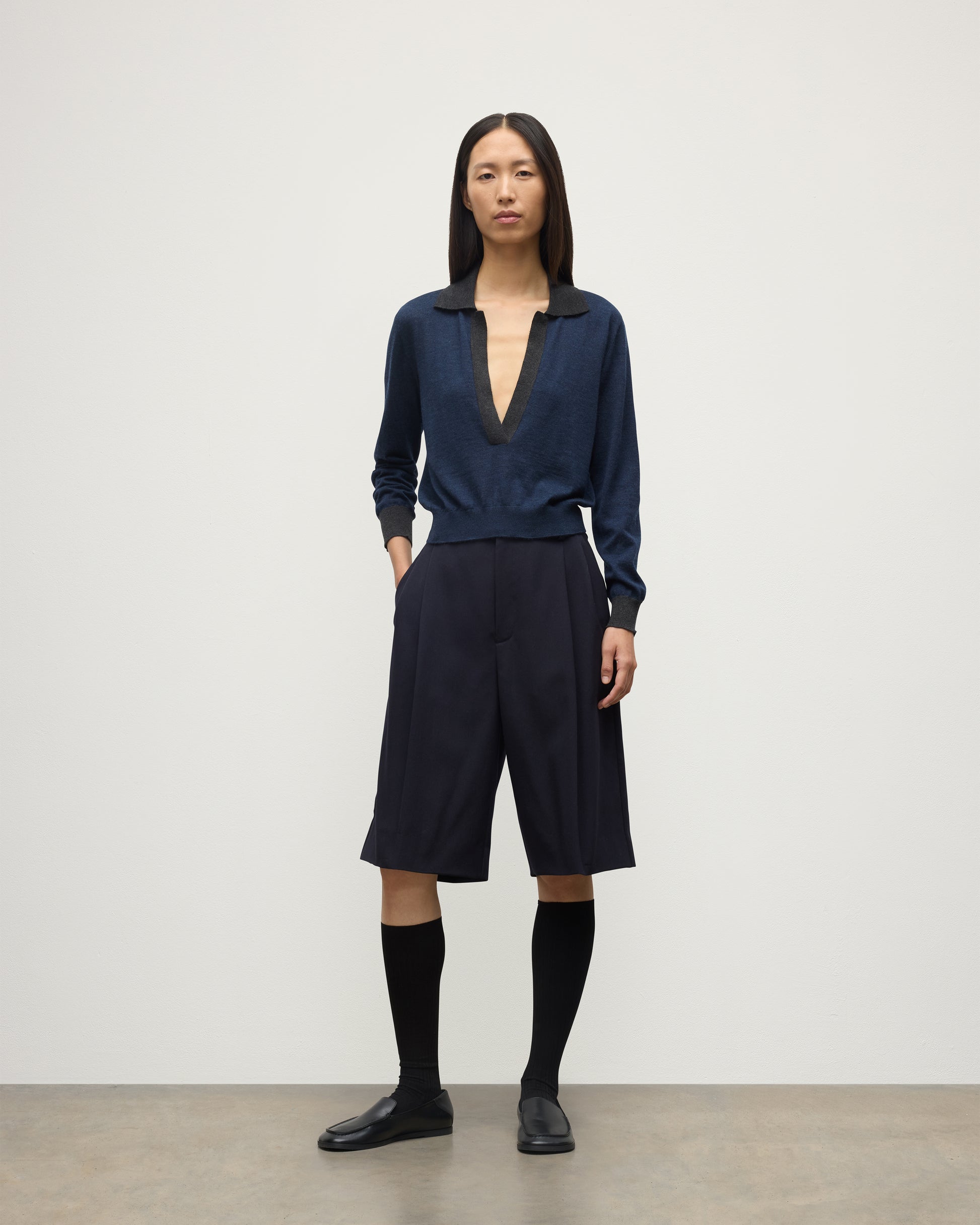 MODEL WEARS JOHNSTONS OF ELGIN WOMENS DEE SHIRT NAVY & GREY 100% SUPERFINE CASHMERE WITH NAVY LONG SHIRTS< SOCKS AND LOAFERS KAI05713Q25962