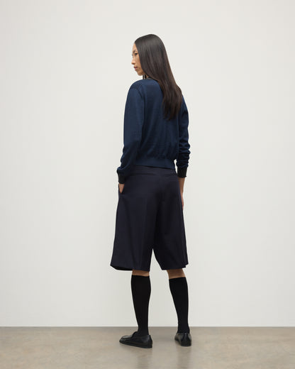 MODEL WEARS JOHNSTONS OF ELGIN WOMENS DEE SHIRT NAVY & GREY 100% SUPERFINE CASHMERE WITH NAVY LONG SHIRTS< SOCKS AND LOAFERS KAI05713Q25962