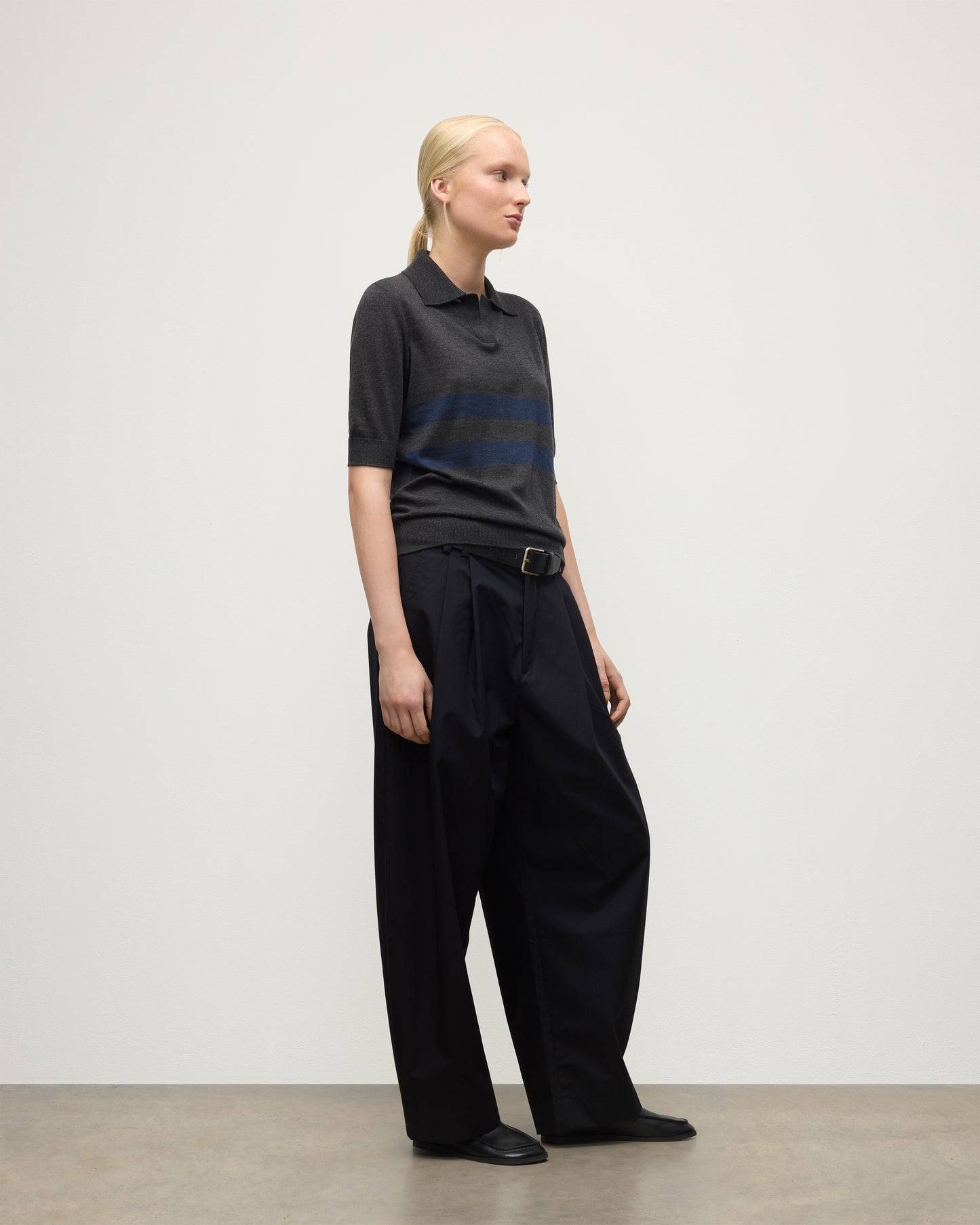 MODEL WEARS JOHNSTONS OF ELGIN WOMENS COIRA SHORT SLEEVE SHIRT GREY & NAVY 100% SUPERFINE CASHMERE WITH BLACK TROUSERS KAI05714Q25955