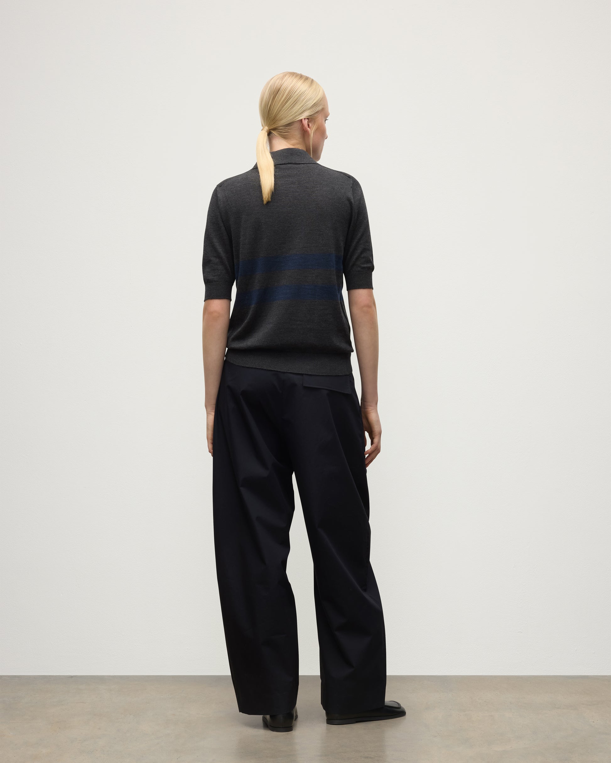 MODEL WEARS JOHNSTONS OF ELGIN WOMENS COIRA SHORT SLEEVE SHIRT GREY & NAVY 100% SUPERFINE CASHMERE WITH BLACK TROUSERS KAI05714Q25955