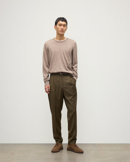 MODEL WEARS JOHNSTONS OF ELGIN MENS FIN SUPERFINE CREW LIGHT BROWN 100% SUPERFINE CASHMERE OVER A WHITE T-SHIRT WITH OLIVE GREEN TROUSERS  KAI05717HB0273