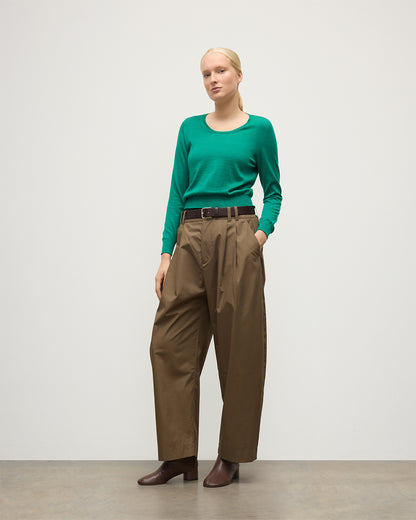 MODEL WEARS JOHNSTONS OF ELGIN WOMENS ELLA SCOOP SWEATER GREEN 100% SUPERFINE CASHMERE WITH BROWN WIDE LEG TROUSERS  KAI05723SC4714