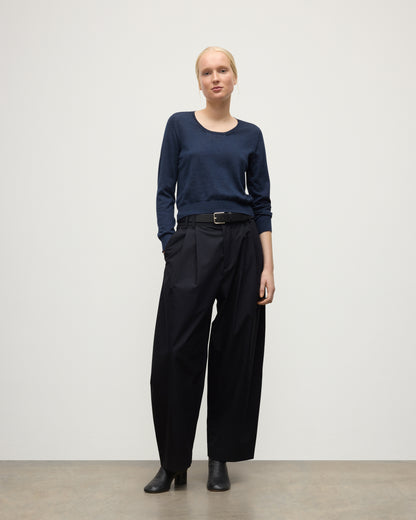 MODEL WEARING JOHNSTONS OF ELGIN WOMENS ELLA SCOOP SWEATER NAVY WITH BLACK TROUSERS AND BOOTS KAI05723HD7350