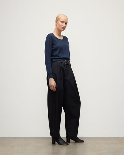 MODEL WEARING JOHNSTONS OF ELGIN WOMENS ELLA SCOOP SWEATER NAVY WITH BLACK TROUSERS AND BOOTS KAI05723HD7350