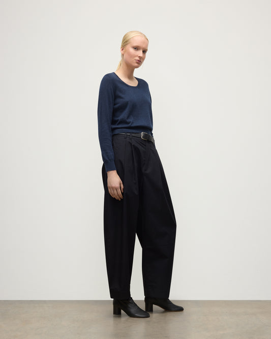 MODEL WEARING JOHNSTONS OF ELGIN WOMENS ELLA SCOOP SWEATER NAVY WITH BLACK TROUSERS AND BOOTS KAI05723HD7350