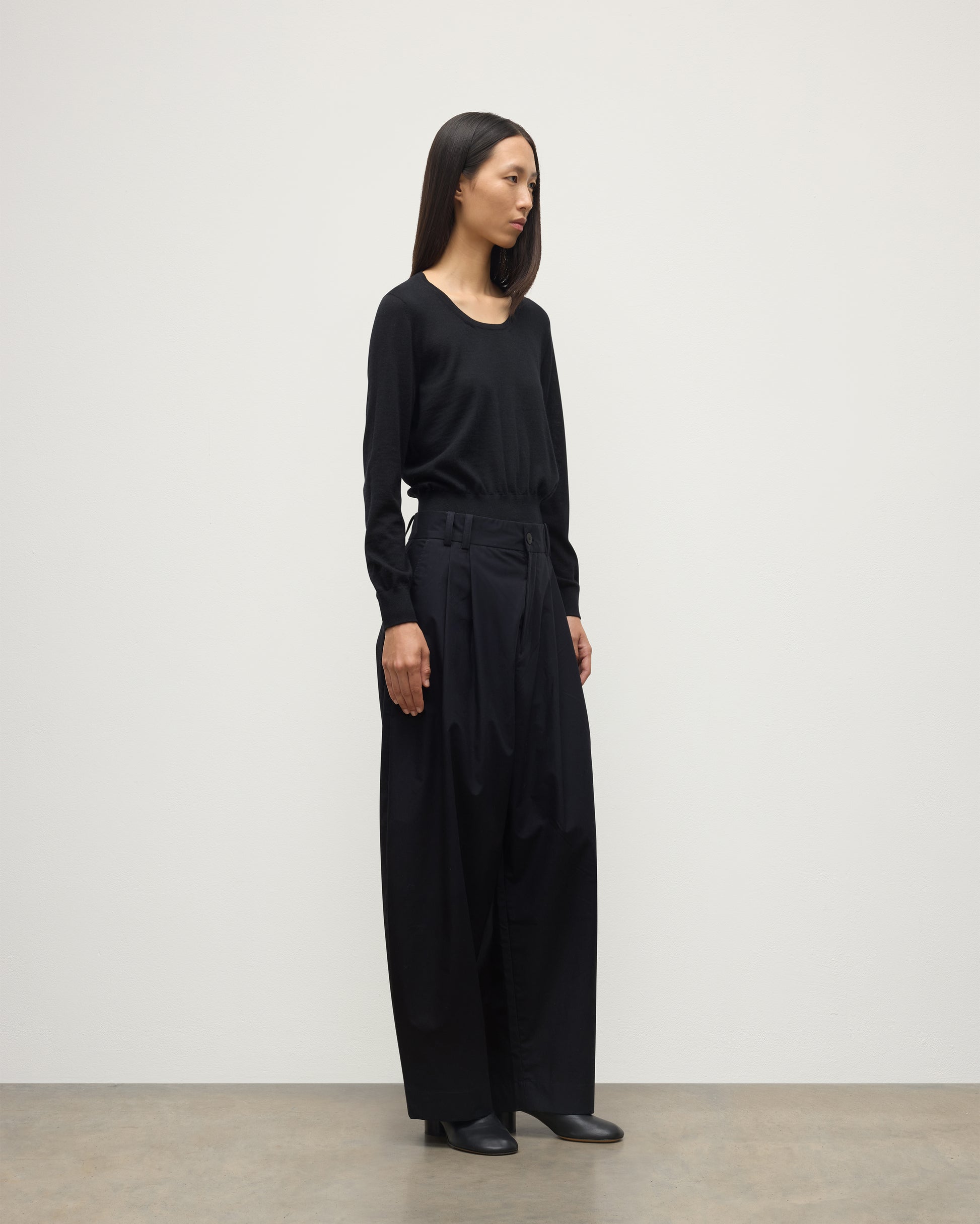 MODEL WEARING JOHNSTONS OF ELGIN WOMENS ELLA SCOOP SWEATER BLACK WITH BLACK TROUSERS KAI05723SA7146